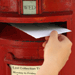 Letter being posted into postbox